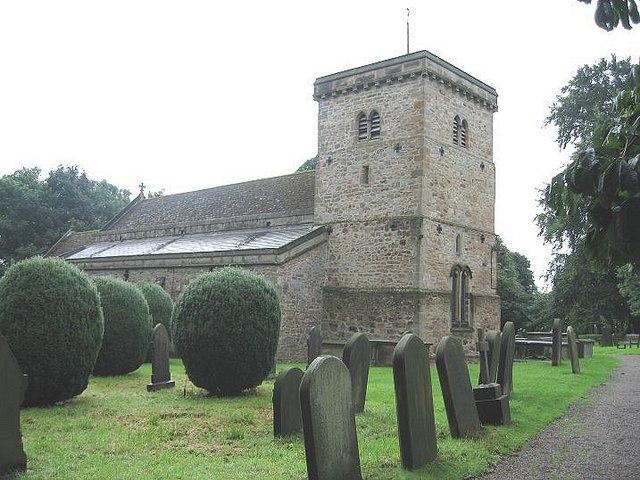 Church of St Michael And Grave Cover Leaning On Buttress Beside North Door